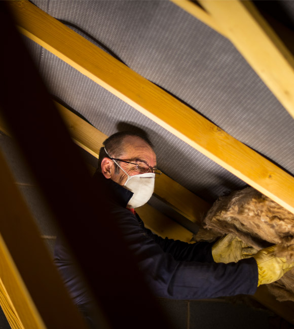 man in an attic with mask and gloves on